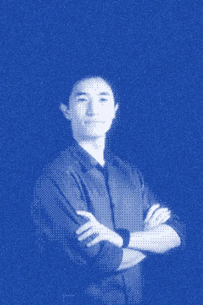 Arlan Baikurazov standing with his arms crossed, printed as a blue halftone.